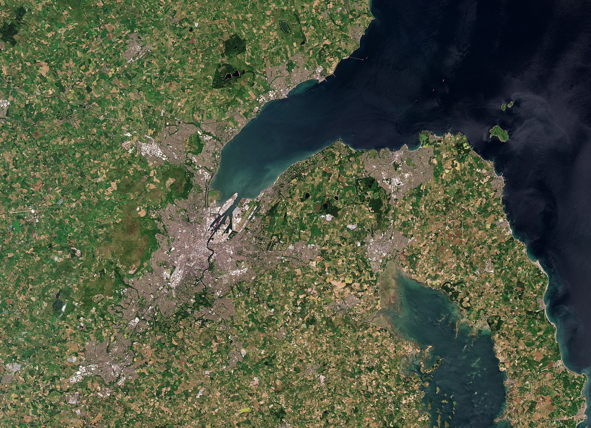 Satellite view of Belfast at the head of Belfast Lough, green fields all round